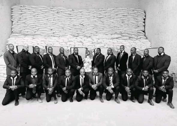 KM VIP Protection full company team photo in formal black suits